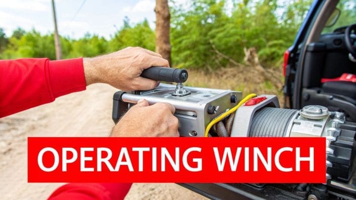 A winch in operation, pulling a vehicle with the winch line under tension.