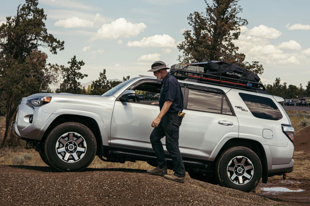 A driving instructor instructs an attendee at an Overland Expo event